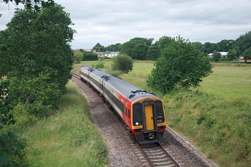 159014, SW 13.25 Exeter St. Davids-London Waterloo (1L52, 21L), Newtown SY068990 
 159014 passes through the green and pleasant Devon countryside with the 13.25 Exeter St. David's to Waterloo. This lovely spot was at Newton between Whimple and Feniton. Hard to believe that this was once a primary double track line carrying famous titled trains such as the 'Atlantic Coast Express'. However, could the good times return with discussions under way to re-double the line in its entirety? 
 Keywords: 159014 1L52 Newtown SY068990