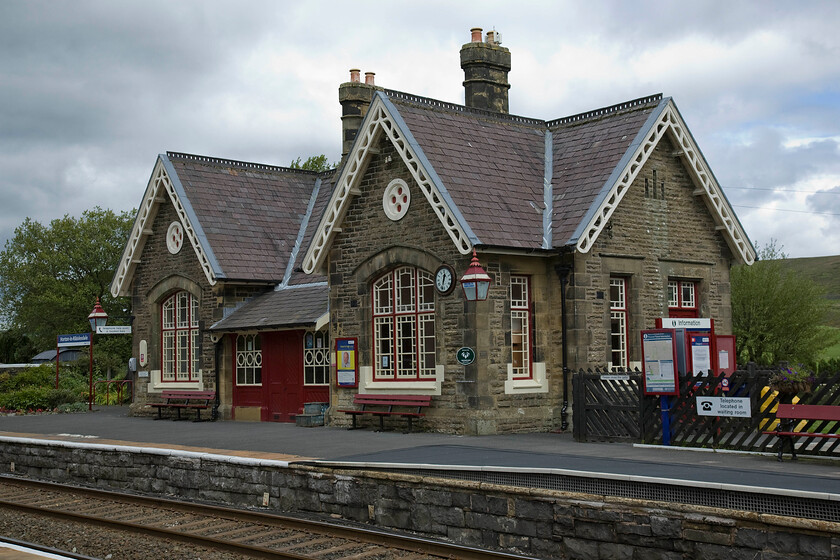 Horton-in-Ribblesdale station 
 Horton-in-Ribblesdale station is a delightfully balanced and symmetrically designed building penned by the Midland Railway company architect John Holloway Sanders. It was opened in 1876 simply named Horton to gain its present name in 1923. It was closed to passengers in 1970 under BR but following the reprive of the Settle and Carlisle line, it was reopened, along with a number of other stations on the route, in 1986. The building is now a private residence and certainly looks to be in far better condition than when I visited in 1980, see...... https://www.ontheupfast.com/p/21936chg/29532792604/horton-ribblesdale-station-midland 
 Keywords: Horton-in-Ribblesdale station