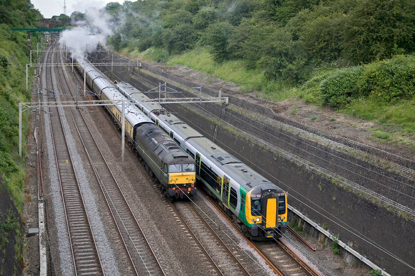 D1755, return leg of The Midlander, 17.43 London Euston-Birmingham New Street(1Z87) & 350103, LM 17.33 Birmingham New Street-London Euston (1W24), Roade cutting 
 As The Midlander disappears through Roade cutting with D1755 dead in tow on the rear London Midland's 350103 works the 17.33 Birmingham New Street to Euston. Out of sight on the front of the charter is 46233 'Duchess of Sutherland' leading the return leg of the charter from Euston to Birmingham New Street. 
 Keywords: D1755 The Midlander, 17.43 London Euston-Birmingham New Street 1Z87 350103 17.33 Birmingham New Street-London Euston 1W24 Roade cutting London Midland Desiro