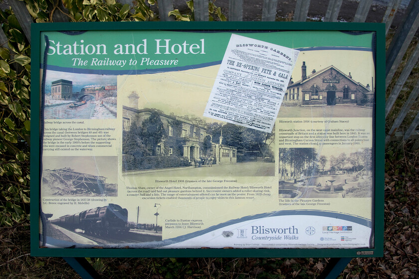 Information board, site of Blisworth station 
 Researched and compiled by the Blisworth Heritage Society this very informative board is located on the site of the village's former station. The station that closed in 1960 was a significant junction marking the point where the second of the two routes into Northampton diverged from the WCML (Weedon loop). Many argue that the route from Blisworth should have been the one retained and electrified rather than the line that diverges just north of Roade cutting. There was also a second line that diverged at Blisworth that headed west built by the former Northampton and Banbury Railway towards Towcester. This later became part of the fabled Stratford-upon-Avon and Midland Junction Railway (SMJR) that has a fascinating history that has filled a number of books. All that exists now at Blisworth are a few PW sidings, a lot of overgrown space and the twin tracks of the WCML behind the inevitable palisade fencing. 
 Keywords: Information board site of Blisworth station