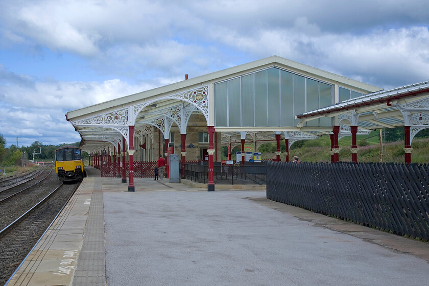 150118, NT 11.14 Leeds-Heysham Harbour (2H84) Hellifield station 
 Hellifield station is a superb structure that is disproportionately large for the settlement it serves. However, the Midland Railway built it at what became a busy junction and deemed that it should be this size. Today the 1880 built structure that was designed by the esteemed and Midland Railway 'favourite' Charles Trubshaw is Grade II listed and undergoes regular maintenance to keep it looking good. However, vast swathes of the platforms surrounding the building are overgrown and spoil the overall ambiance. 150118 pauses at the station working the 11.14 Leeds to Heysham Harbour service. 
 Keywords: 150118 11.14 Leeds-Heysham Harbour 2H84 Hellifield station Northern