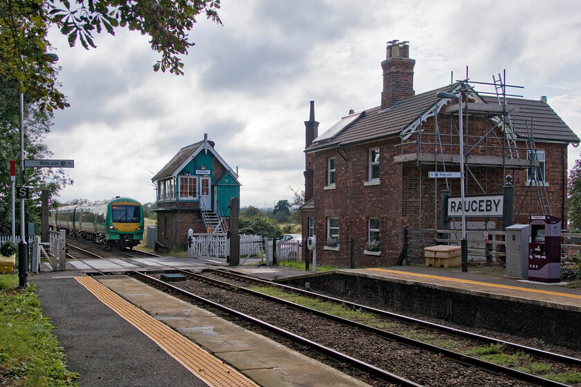 170423, EM 15.45 Nottingham-Skegness (2S23, RT), Rauceby station 
 Still wearing its Southern livery 170423 passes Rauceby working EMR's 2S23 15.45 Nottingham to Skegness service. When I last visited Rauceby back in 2010 I was informed by the signalman on duty that the box, along with Ancaster to the west, was to be replaced soon when the Sleaford to Lincoln MAS scheme was introduced. Whilst the MAS went live in 2014 it looks like Network Rail's plans changed as thirteen years later semaphore signalling is still in place along with hand-operated crossing gates; long may this continue! Notice the work taking place on the former station house. It looks like the ornate Great Northern bargeboarding is being reinstated; a nice touch. 
 Keywords: 170423 EM 15.45 Nottingham-Skegness 2S23 Rauceby station