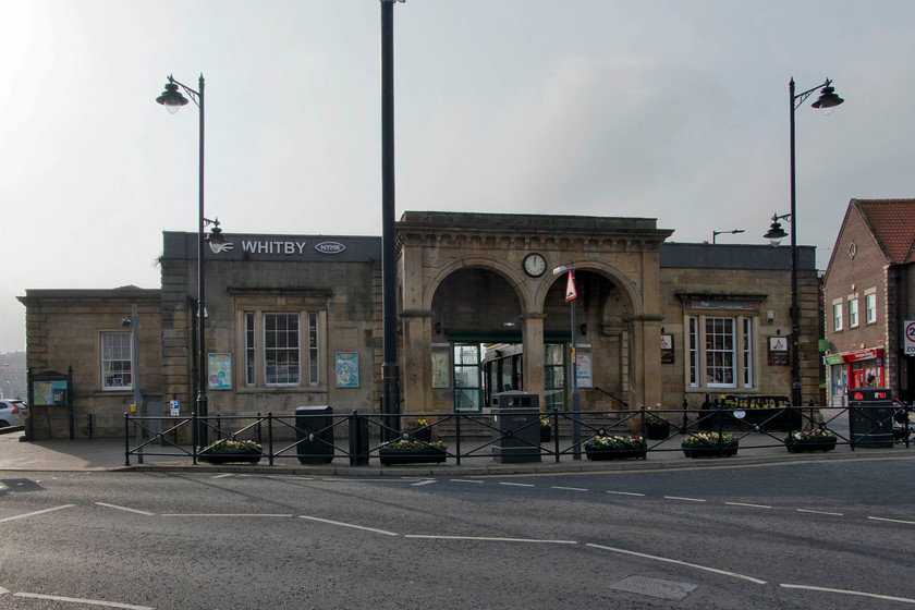 Frontage, Whitby station 
 The last picture that I took of Whitby station's frontage was very different to how it does in 2019, see..... https://www.ontheupfast.com/p/21936chg/29786091004/station-frontage-lner-clock-whitby The Wonderfull arches and matching mullion windows were covered up by, from left to right, a newsagent, a tobacconists and an electrical shop. The only entrance to the station was to the left-hand side and a very run down it was too. However, the station and section of line to Grosmont has undergone a bit of a revival in recent years with the return of steam to the mainline as the NYMR operate some of their service trains through to Pickering from Whitby. Indeed, the NYMR insignia can be seen next to the station name above the left-hand mullion. The station interior has been hugely improved with the second platform and track reinstated and a run round facility for the steam locomotives. 
 Keywords: Frontage Whitby station