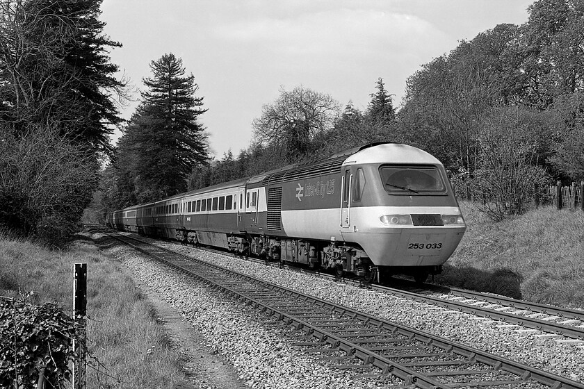 253033, unidentified up diverted working, Bradford-on-Avon no. 2 crossing, ST821605 
 Taken from what I named foot crossing number 2 HST set 253033 heads along the Avon Valley on the approach to Bradford-on-Avon. The HST set was heading for Paddington diverted away from its more normal route due to engineering works somewhere on the GWML. This power car would have been one of either W43135 or W43136 both of which are still in service today operating in Scotland. I visited this spot in 2014 when there was also diversions, this time due to electrification works, illustrating that the growth of the trees has been incredible, see.... https://www.ontheupfast.com/p/21936chg/30018090440/x43187-11-00-cheltenham-london-paddington 
 Keywords: 253033 unidentified up diverted working Bradford-on-Avon no. 2 crossing ST82160 HST Class 43