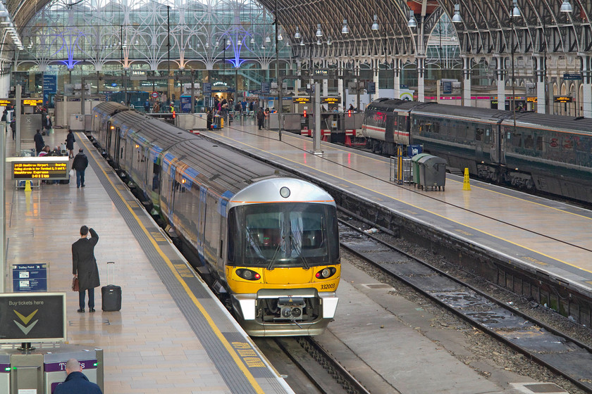 332003, HX 14.25 London Paddington-Heathrow T5 (1T61) & 43185, GW 12.00 Bristol Temple Meads-London Paddington (1A16), London Paddington station 
 The glorious train shed at Paddington has undergone a huge refurbishment and renovation programme over the years, As a result of this work, it is a pleasant and airy place to be, gone are the days of it being a dark and fume filled environment. In the foreground, the 14.25 Heathrow Express service to Heathrow Terminal five waits to leave whilst, 43185 'Great Western' has arrived earlier with the 12.00 from Temple Meads. Despite many opportunities to use Heathrow Express, I have found their fares to be extortionate, even when paying advanced prices with railcards. This does smack a little of exploiting the tourist trade and taking advantage of foreign visitors who do not have the opportunity of knowledge to shop around. 
 Keywords: 332003 14.25 London Paddington-Heathrow T5 1T61 43185 12.00 Bristol Temple Meads-London Paddington 1A16 London Paddington station