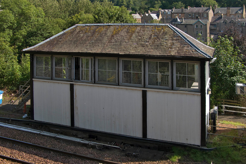 Dunblane signal box (Caledonian, 1902) 
 Taken from the footbridge that spans the line to the north of the station Dunblane's 1902 Caledonian signal box is seen. Until the South box closed in 1955 this was Dunblane North. It controls all the semaphores and points within the station area and it can get pretty busy at times with numerous terminating trains needing to pull forward from the station and cross over to return south again. The box is a later design with the Caledonian having moved away from their traditional red-brick structures to timber. Underneath the more recently applied UPVC cladding is a timber frame. The roof is an example of a crowstep gabled design by William Tite and is probably original. With the arrival of the electrification over the coming few years the importance of the box will be somewhat diminished with it becoming the first block post north towards Perth. 
 Keywords: Dunblane signal box Caledonian