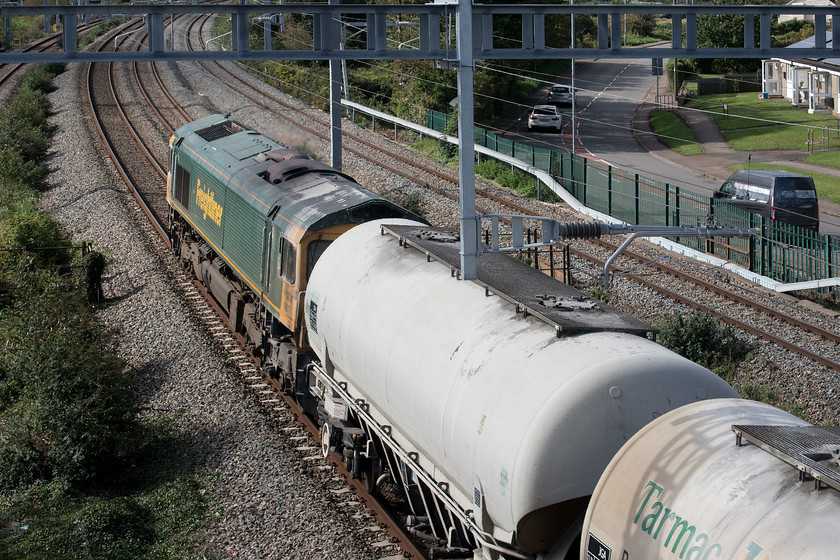 66617, 12.20 Westbury-Tunstead sidings (6M36), Undy 
 A grab-shot of 66617 passing Undy with the 6M36 12.20 Westbury to Tunstead cement wagons. This train takes a very contorted journey from West Wiltshire to the Derbyshire Peak District via Bristol, South Wales and Crewe. This image is all that I could manage here at Undy, once a very popular spot for photographers and spotters alike now rendered impossible by the installation of a gargantuan and totally over-engineered footbridge. I had no view of this train but merely help my camera over the parapet and pointed in the direction that I thought about right, quite remarkably, I did get it right so have included it but not on that basis rather than on any other photographic merit! 
 Keywords: 66617 12.20 Westbury-Tunstead sidings 6M36 Undy