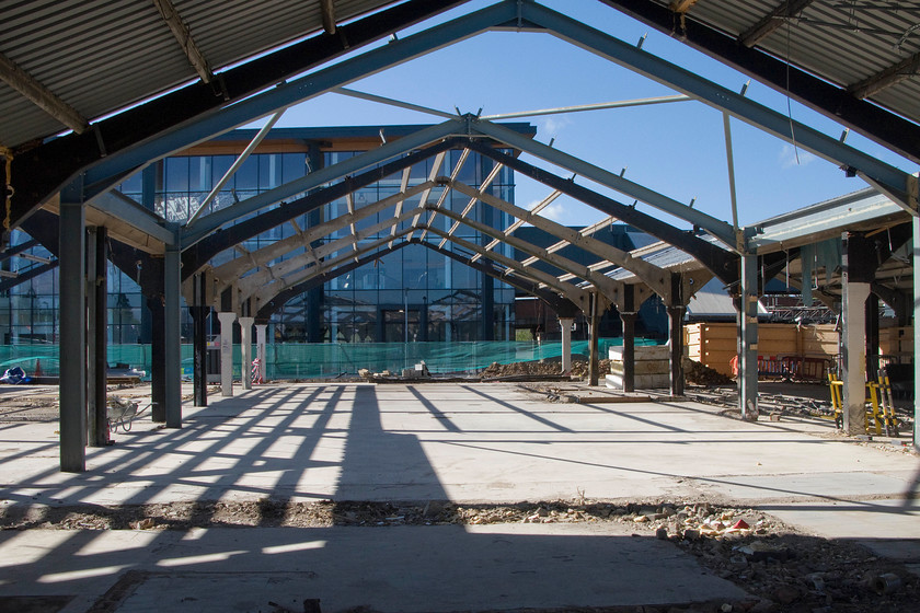 Demolition of old Northampton station 
 The new Northampton station building opened some three months ago and is seen in the background in this picture. In the foreground is the framework of the old station, designed by the architect Ray Moorcroft, that was opened in 1966. The view is looking through one of the three 'cowsheds' as they were rather unfortunately referred to! 
 Keywords: Demolition of old Northampton station