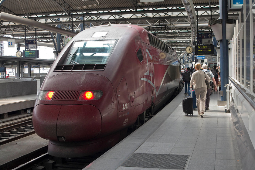 43 310, 12.37 Brussels Midi-Paris Nord (THA 9336), Brussels Midi station 
 Passengers make their way along platform 4a at Brussels Midi station in order to catch the 12.37 to Paris Nord, THA 9336 service. It is being worked by one of Thalys PBA sets number 4331. This class 43 (not be confused with the UK class 43 HSTs!) were introduced in 1998 and are based on the french TGV platform. 
 Keywords: 43 310 12.37 Brussels Midi-Paris Nord THA 9336 Brussels Midi station