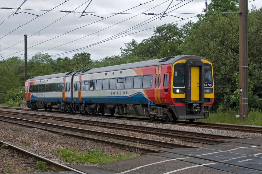 158785, EM 10.40 Nottingham-Norwich (1L07, 2E), Lolham level crossing 
 Express Sprinter 158785 passes over Lolham level crossing just south of Tallington working EMR's 10.40 Nottingham to Norwich train. This was another EMR service that did not originate from its planned starting point of Liverpool Lime Street, something that EMR has failed to sort out since the new timetable commenced back in December. 
 Keywords: 158785 10.40 Nottingham-Norwich 1L07 Lolham level crossing EMR Express Sprinter