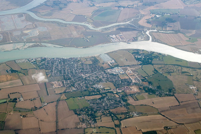 Burnham-on-Crouch, from flight SU2582 
 Our flight back from Moscow to Heathrow brought us in over the Essex coast as we descended in preparation for landing. In this view, looking south from Aeroflot flight SU2582, the town of Burham-on-Crouch is seen in the afternoon sunshine. The branch line to Southminster can be seen curving from mid-right to lower-left. In the lower right-hand corner, the line of trees weaving through the harvested wheat fields marks the route of Mangapps Farm railway, see.... http://www.mangapps.co.uk/index.html 
 Keywords: Burnham-on-Crouchflight SU2582