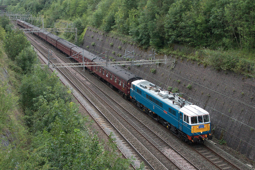 86259, outward leg of The Cumbrian Mountain Express, 07.10 London Euston-Carlisle (1Z86), Roade Cutting 
 86259 'Les Ross/Peter Pan' leads The Cumbrian Mountain Express through Roade Cutting. The excursion left London Euston at 07.10 heading for Carnforth running with its usual headcode of 1Z86. At Carnforth, steam took the train over Shap to Carlise. 
 Keywords: 86259 The Cumbrian Mountain Express 07.10 London Euston-Carlisle 1Z86 Roade Cutting