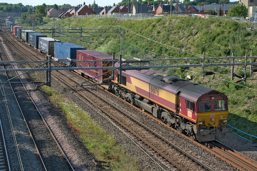 66176, 16.50 DIRFT-Grangemouth (4M49, 30E), Ashton Road bridge 
 66176 is a member of the class that has eluded me. I have only one other photograph of it and that was a poor one with it being the second locomotive double-heading a freight at Marholm way back in 2010. It is seen here passing Roade leading an unusual working that looks for all intents and purposes like a perfectly normal up Freightliner. However, this is the 4M49 16.50 Daventry to Grangemouth that is taking a circuitous route to reach Scotland via London and the ECML. With no air conditioning in the cabs and continued complaints from drivers about unpleasant conditions, as is usual on hot days, they will drive with the cab doors open to aid ventilation. I am not sure if this is allowed according to the rule book! 
 Keywords: 66176 16.50 DIRFT-Grangemouth 4M49 Ashton Road bridge