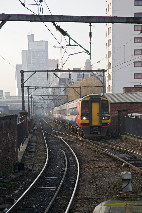 158846 & 158864, EM 11.52 Liverpool Lime Street-Norwich (1L10), Manchester Piccadilly station 
 A well used spot by photographers is at the end of Manchester Piccadilly's platforms 13 and 14 looking west. From that vantage point, 158846 and 158864 arrive with the 11.52 Liverpool Lime Street to Norwich 1L10 working. With all the developments going on in Manchester, it is sometimes hard to remember it as the 'dirty northern town', as painted by its favourite son L S Lowry, that it once was. 
 Keywords: 158846 158864 11.52 Liverpool Lime Street-Norwich 1L10 Manchester Piccadilly station