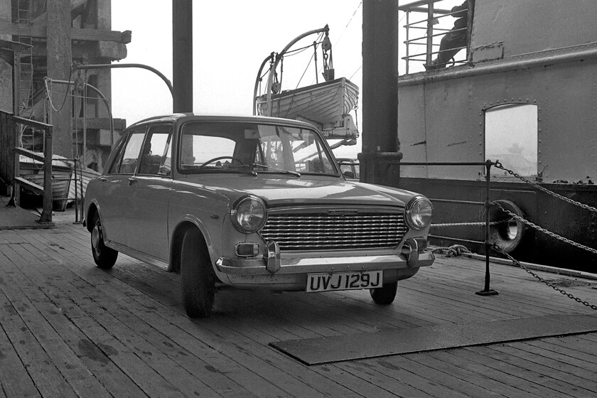 UVJ 129J, loading pontoon, New Holland Pier 
 I make no apologies for including this portrait of Graham's trusty stead UVJ 129J. It carried us on numerous trips around the country with varying degrees of reliability between 1980 and 1983. It was a Hereford-registered vehicle that had been passed to Graham by his father who lived in the city. Despite its smart appearance here sitting on the New Holland loading pontoon adjacent to MV Farringford, it did suffer with the usual Austin 1100 rust malaise. Graham was the final keeper with it on the road until 1984 when it was scrapped and replaced by another of his father's hand-me-downs, a 1981 Metro. 
 Keywords: UVJ 129J loading pontoon New Holland Pier Austin 1100