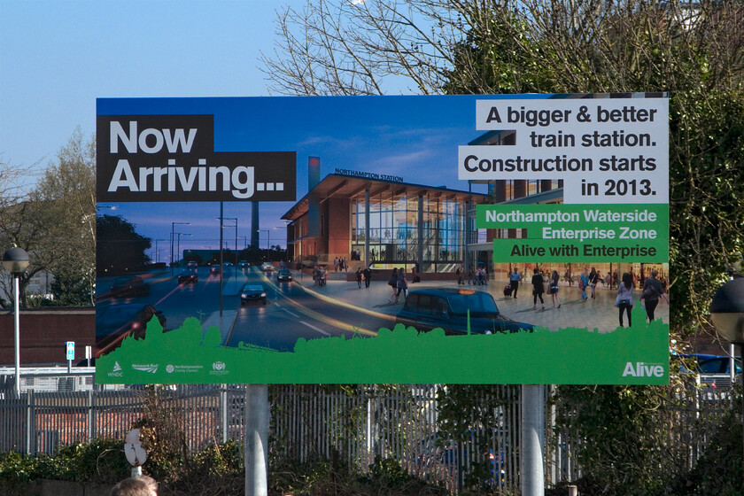 Promotional signage, Northampton station 
 The promise of things to come! This is what the rail-travelling public of Northampton will be greeted within a year or two's time and not before time. The present station is now hopelessly outdated and inadequate so the new station should be welcomed by all. 
 Keywords: Promotional signage, Northampton station.