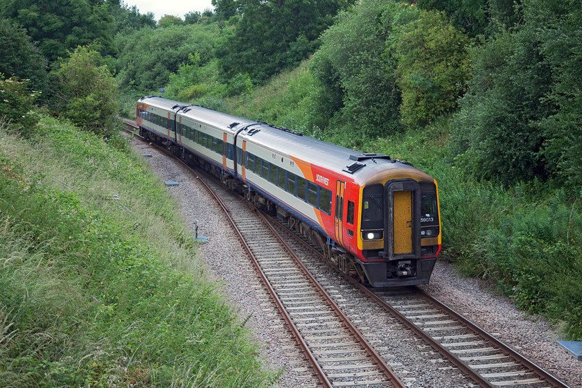 159013, SW 11.20 London Waterloo-Exeter St. Davids (1L29, RT), Queen Street bridge, Honiton 
 Looks can be deceiving, this is not a rural location but in the middle of Honiton just east of the station. From Queen Street bridge in the town 159013 is seen forming the 11.20 Waterloo to Exeter St. David's. Honiton has a passing loop and a completely re-built station that opened in 2011. 
 Keywords: 159013 1L29 Queen Street bridge, Honiton