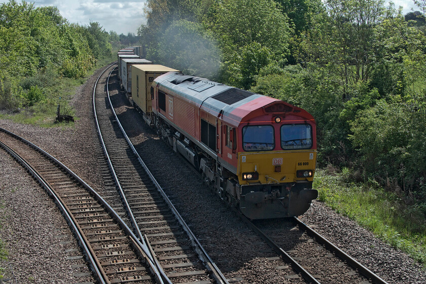 66009, 08.00 Felixstowe South-East Midlands Gateway (4M79, 3E), March West Junction 
 66009 makes a smokey departure from March leading the 08.00 Felixstowe South to East Midlands Gateway service. Apologies for this image taken on the wrong side for the sun. Andy and I only became aware of the train as we were walking away from the footbridge dashing back to capture this scene. Notice the spur leading off to the left. This leads to the busy Whitemoor Yard that is now the centre of NR's infrastructure activities for the east of England having morphed from its previous role as a large marshalling yard and diesel depot, see.... https://www.ontheupfast.com/p/21936chg/25366288004/x37050-31326-stabled-march-mpd 
 Keywords: 66009 08.00 Felixstowe South-East Midlands Gateway 4M79 March West Junction DB Freightliner