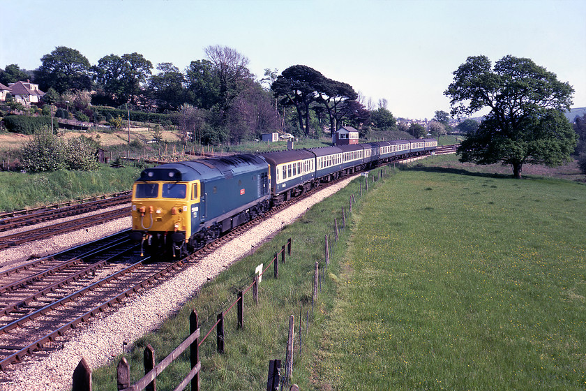 50019, 14.00 Penzance-Birmingham New Street (1M74), Aller Junction 
 Relatively fresh after its Doncaster overhaul and still looking smart 50019 'Ramillies' leads the 14.00 Penzance to Birmingham New Street past Aller Junction. 50019 was the fourth member of the class to be overhauled that took it out of traffic for nearly a year with it entering the works in July 1979. By the end of the overhaul programme, the locomotives were turned around a lot more quickly with some taking considerably less than five months. Notice the signal box in the background where the signalman will have been kept busy on this spring Saturday and his VW Beetle parked up behind the box. 
 Keywords: 50019 14.00 Penzance-Birmingham New Street 1M74 Aller Junction Ramillies