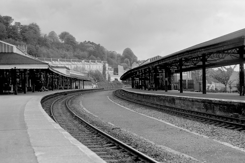 Looking west, Bath Spa station 
 Looking west from the end of Bath Spa's platform one reveals empty platforms! The gap in the centre of the image once had two passing-lines and a series of crossovers that allowed wagons to pass from the small turntable to my left to the goods yard and shed at the far end of platform two. It was a complicated affair but one forced on the station due to its chronically constrained site. Ironically, it is these constraints that have led to the station retaining so many of its original features. 
 Keywords: Looking west Bath Spa station