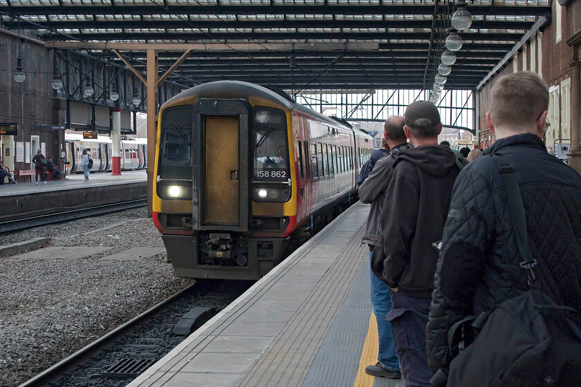 158862, EM 15.08 Crewe-Newark Castle (2N61, 15L), Stoke-on-Trent station 
 A late-running 158862 arrives at a surprisingly busy Stoke-on-Trent station. At this point, the 15.08 Crewe ro Newark Castle service was running some twenty minutes late but we had no other choice than to take this train as it was the only one heading east on routes permitted by our East Midlands Day ranger ticket. On arrival at Derby, it had reduced the deficit to some ten minutes but this was not enough for staff to hold the outgoing service to Birmingham that Andy and I were hoping to take to Tamworth, plan B into operation then! 
 Keywords: 158862 15.08 Crewe-Newark Castle 2N61 Stoke-on-Trent station