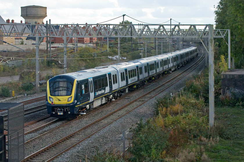 701035 & 47749, 10.00 Derby Litchurch Lane-Wimbledon Park Depot (5Q90, 54L), site of Roade station 
 Looking very smart and making its first run out on the mainline 701035 is towed southwards past the site of Roade station. It will soon arrive (if rather late!) at Wimbledon Depot facing a very uncertain future. Despite deliveries of these Aventra units commencing in early 2020 none have entered service yet. COVID delayed trails and staff training last year but issues have since emerged pertaining to their software and practicalities relating to sighting. Rather like the delayed introduction of the Class 385s in Scotland back in 2018 the unions have blacked the units until modifications are made. Whilst the 385s had redesigned windscreens due to internal reflection issues with the 701s it is the parked windscreen wipers obstructing the view of signalling! I really do not understand how such a seemingly simple issue as this was not recognised and dealt with at the pre-production mock up stage? And as for the software issues....don't get me started on that one! 
 Keywords: 701035 47749 10.00 Derby Litchurch Lane-Wimbledon Park Depot 5Q90 site of Roade station City of Truro Aventra SWR South Western Railway