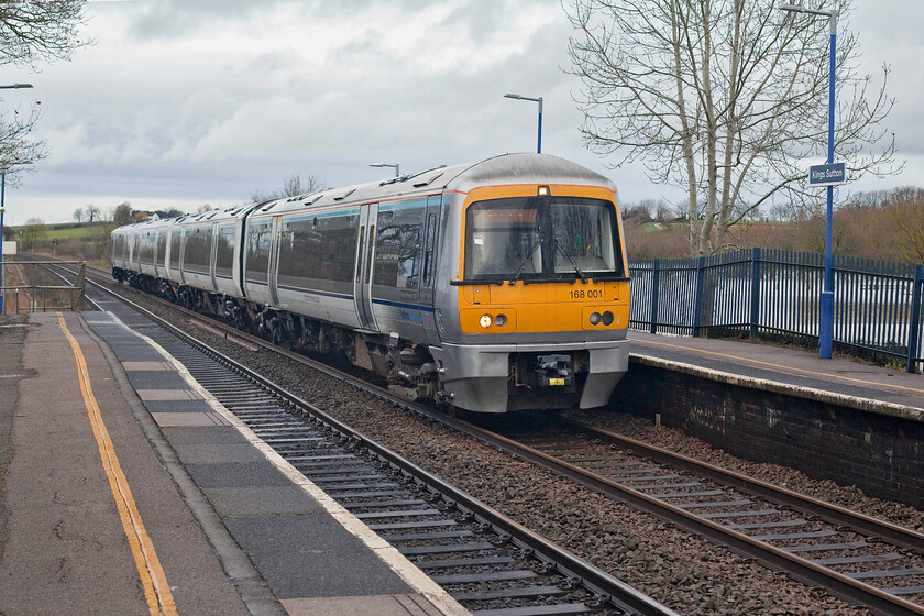 168001, CH 11.05 Banbury-London Marylebone ECS (5H22, 16E), King's Sutton station 
 On the day that Andy and I were out to see the Shooter's Swansong charter in memory of the career railwayman who died on 13.12.22 168001 named 'Adrian Shooter CBE' was also seen and photographed passing through King's Sutton. Passing the flooded fields near the village the Turbo unit is seen working the 5H22 11.05 Banbury to Marylebone empty coach stock move. 
 Keywords: 168001 11.05 Banbury-London Marylebone ECS 5H22 King's Sutton station Chiltern Turbo Adrian Shooter CBE