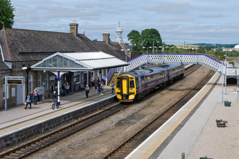 158709, SR 12.00 Aberdeen-Inverness (1H31), Inverurie station 
 Inverurie is a smashing station that was busy with passengers and visitors many of whom were using the excellent little coffee shop that Andy and I also took advantage of. This station was opened by the Great North of Scotland Railway in 1902 when the company also built its main railway works on land beyond the station where the two tall trees are growing. In this scene, 158709 is pausing with the 1H31 12.00 Aberdeen to Inverness train. 
 Keywords: 158709 12.00 Aberdeen-Inverness 1H31 Inverurie station ScotRail Sprinter