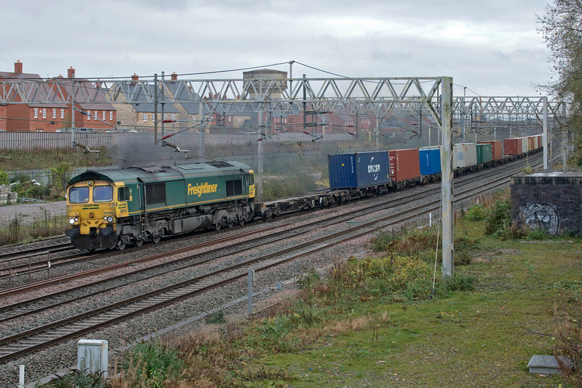 66550, 09.46 Felixstowe North-Crewe Basford Hall (4M87, 18L), site of Roade station 
 Leaving a heavy smoke train across Roade 66550 leads the 09.46 Felixstowe to Crewe Basford Hall Freightliner. The train had been held for some time at Hanslope Junction whilst a procession of Pendolinos had crossed from the up and down slow lines to the fast ones due to the emergency closure of the Weedon route. I thought that this particular Class 66 would be staying at Basford Hall for attention given its smokey engine but I saw it back in August when its engine was equally as bad, see.... https://www.ontheupfast.com/p/21936chg/29395248604/x66550-12-16-lawley-street-felixstowe. If it was a car that appeared in my garage for an MoT test it would fail on emissions so Freightliner really needs to deal with this. 
 Keywords: 66550 09.46 Felixstowe North-Crewe Basford Hall 4M87 site of Roade station