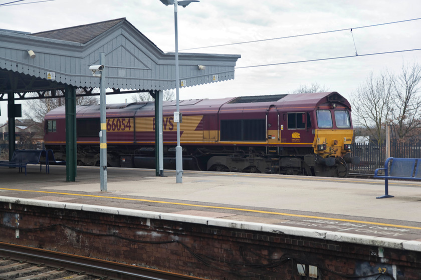 66054, stabled, Didcot Parkway station 
 Since the closure of the coal fired Didcot Power Station, adjacent to the railway station, freight activity in the vicinity has declined markedly. Whilst there are still numerous freights passing the station the sight of several locomotives stabled next to the station has all but gone. However, here 66054 sits awaiting its next turn of duty at Didcot Parkway station. 
 Keywords: 66054 Didcot Parkway station