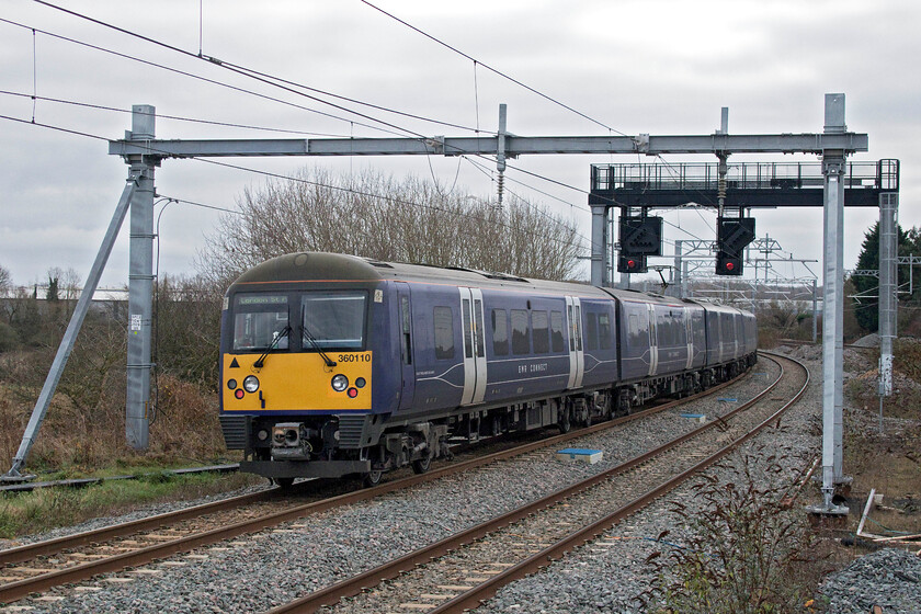 360110, EM 11.40 Corby-London St. Pancras (1Y26, RT), Wellingborough station 
 The rear of the 1Y26 11.40 Corby to St. Pancras EMR Connect service leaves Wellingborough station. The lightly loaded service was being worked by 360110 at the rear with 360105 out of sight at the front. With the signal already having turned red the feather has gone off indicating that the train was moving from the up slow to the fast line at the scissor junction just around the curve south of Wellingborough station. 
 Keywords: 360110 11.40 Corby-London St. Pancras 1Y26 Wellingborough station EMR Connect Desriro