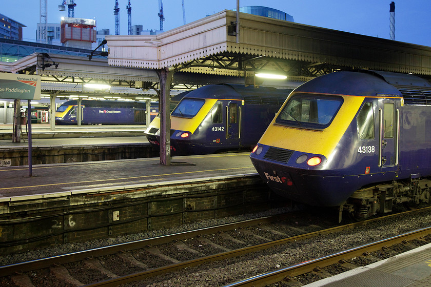 43155, 43142 & 43138, various workings, London Paddington station 
 A classic line up of four HSTs at Paddington station taken in the half-light one day away from the longest day in June. The identified ones are 43155 'The Red Arrows 50 Seasons of Excellence', and unidentified power car, 43142 'Reading Panel Signal Box 1965-2010' and 43138 on platform 2. Unfortunately, it was far too complicated to work out their workings! 
 Keywords: 43155 43142 43138 London Paddington station