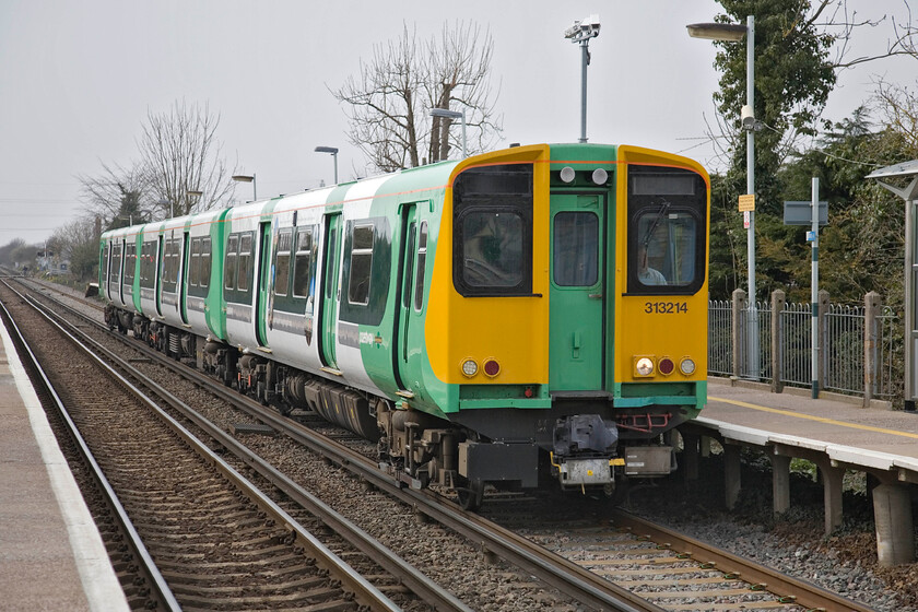 313214, unidentified working ex Portsmouth Harbour, Fishbourne station 
 The Coastway 'stopper' services are generally operated by the venerable Class 313s. 313214 arrives at Fishbourne station working an unidentified service from Portsmouth Harbour. The small village of Fishbourne is probably best known for its superb and relatively early Roman palace that is widely recognised as the largest Roman residence north of the Alps. 
 Keywords: 313214 ex Portsmouth Harbour Fishbourne station Southern