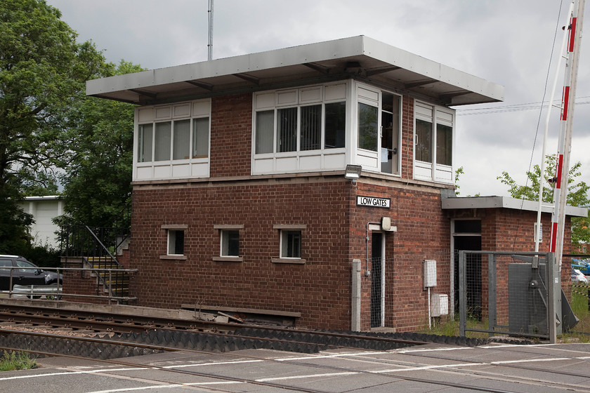 Low Gates signal box (BR, 1956) 
 Low gates signal box was opened by British railways in 1956. It replaced the original box on the opposite side of the line. It took on added importance in 1960 when it took over control of Northallerton East Junction. Whilst the level crossing in the foreground looks quiet it was in-fact a very busy road and getting a vehicle-free picture was a challenge! 
 Keywords: Low gates signal box