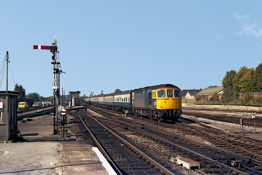 33016, 10.10 Exeter St. Davids-London Waterloo (1O10), Salisbury station 
 33016 enters Salisbury under a perfect clear blue sky with the 1O10 10.10 Exeter St. Davids to London Waterloo. Salisbury West signal box can be seen in this image complete with it large air tank that powers the pneumatic power signaling system that was installed by the L&SWR when the station was re-built and the signaling replaced between 1901 and 1902. 
 Keywords: 33016 10.10 Exeter St. Davids-London Waterloo 1O10 Salisbury station