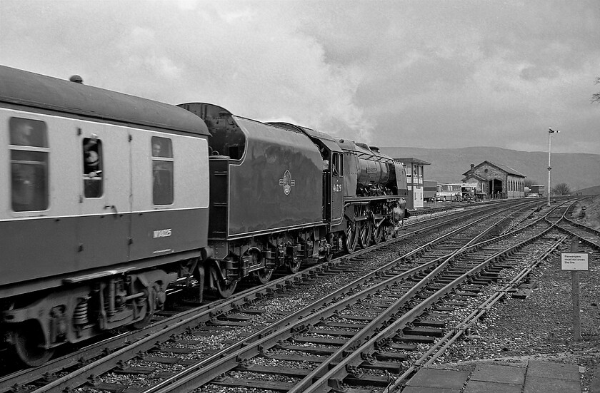 46229, outward leg of The Cumbrian Mountain Express, Carlisle-Hellifield, Kirkby Stepehn station 
 46229 'Duchess of Hamilton' makes a fine sight as it continues its dramatic and confident assault of the Settle and Carlisle line from the north hauling the outward leg of The Cumbrian Mountain Express seen passing Kirkby Stephen. It still has over seven miles of 1:100 climbing to complete until it will crest the summit at Ais Gill. Once again, a successful going-away photograph that reveals plenty of infrastructure at Kirkby Stephen that had changed very little when I visited this spot again in 2014, see...... https://www.ontheupfast.com/p/21936chg/30016458813/kirkby-stephen-signal-box-former 
 Keywords: 46229 The Cumbrian Mountain Express Carlisle-Hellifield Kirkby Stephen LMS Princess Coronation Class Duchess of Hamilton