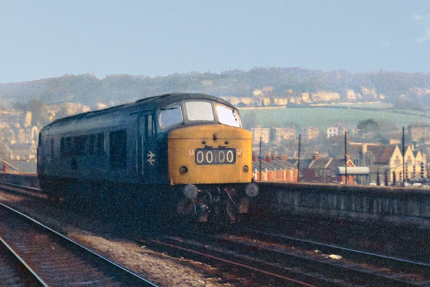 Class 46, down LE, Bath Spa station 
 A light engine class 46 trundles through Bath Spa station heading towards Bristol. I am pretty sure that it would have originated at Westbury. Note its 0000 headcode display. The policy to display the trains proper headcode in this panel had been abandoned at the start of 1976.