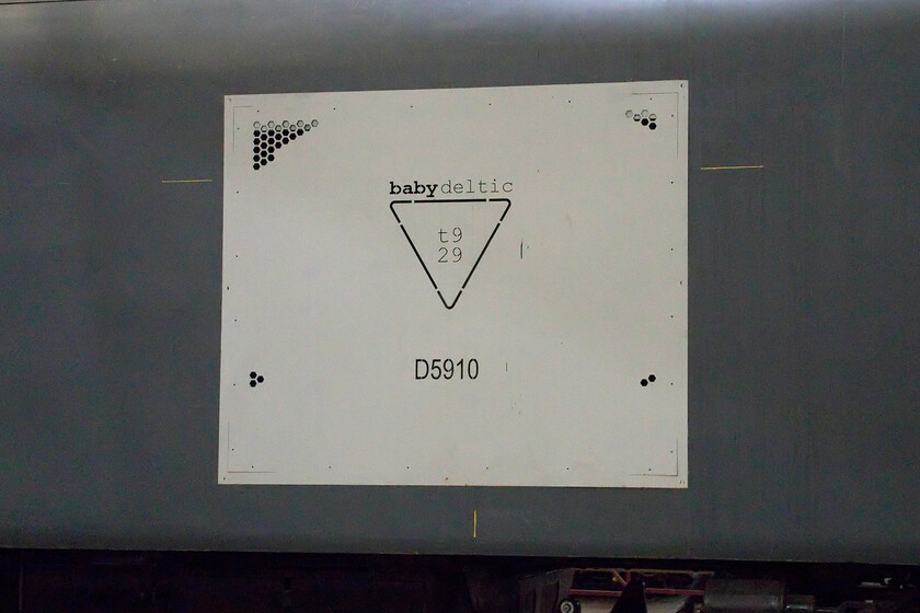 Bodyside, D5910, on display, Barrow Hill Roundhouse 
 The group re-creating a Class 23 'Baby Deltic' have also a brand image for the project. This plaque is attached to the side of the locomotive as it sits on Barrow Hill's roundhouse turntable. Its centre shows the triangle representing the configuration of the nine-cylinder t9 29 Deltic engine. There were ten Class 23s built by English Electric in 1959 with all withdrawn from service by 1971 and cut up bar D5901 that ended up as a test bed at the Derby Railway Technical Centre until it also succumbed in 1975. The work undertaken by the Bady Deltic Project is extraordinary and I really hope that the locomotive will be hauling trains at some time in the future. 
 Keywords: Bodyside D5910 on display Barrow Hill Roundhouse Class 23 Baby Deltic