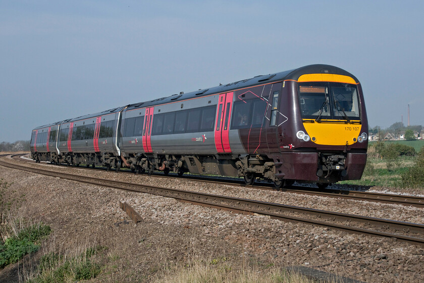 170107, XC 07.05 Gloucester-Stansted Airport (1L00, RT), Harts Drove crossing TL273962 
 Seen and photographed by me all over the network from South Wales to Derby, Leicester, and now over in the Fens CrossCountry's 170107 works the 07.05 Gloucester to Stansted Airport service past Whittlesey. Notice the tall chimneys of the Forterra brickworks located a short distance away at King's Dyke. 
 Keywords: 170107 07.05 Gloucester-Stansted Airport 1L00 Harts Drove crossing TL273962 CrossCountry XC