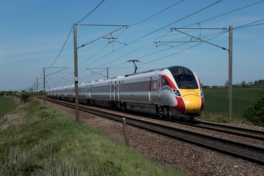 800108, 12.08 Retford-Peterborough (5Q42, 1E), Frinkley Lane crossing SK906436 
 With a cheery wave from the driver, 800108 passes Frinkley Lane crossing north of Grantham working the 12.08 Retford to Peterborough staff training and mileage accumulation run. In their LNER branding, the Azumas look very smart and so much better than their GWR counterparts that wear their awful drab green livery so badly. However, the depot teams will need to work hard to keep the white paintwork looking smart; not the most practical colour! 
 Keywords: 800108 12.08 Retford-Peterborough 5Q42 Frinkley Lane crossing SK906436