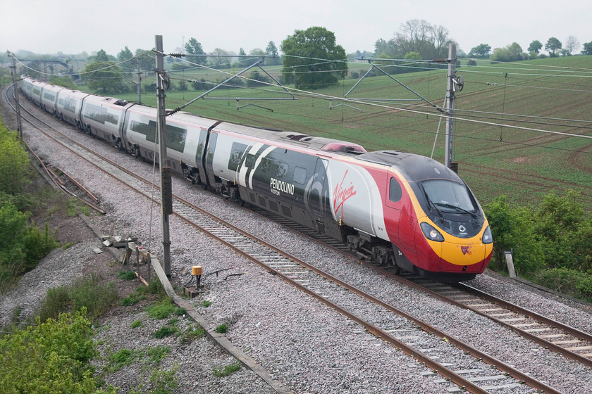 390104, VT 07.30 London Euston-Glasgow Central (1S42, 1L), Blisworth 
 Wearing its one-off branding, 3901104 ' Alstom Pendolino' passes Blisworth with the 1S42 07.30 Euston to Glasgow Central. This is the last train that control let through the Weedon Loop before allowing the 86 hauled to head north. 
 Keywords: 390104 1S42 Blisworth