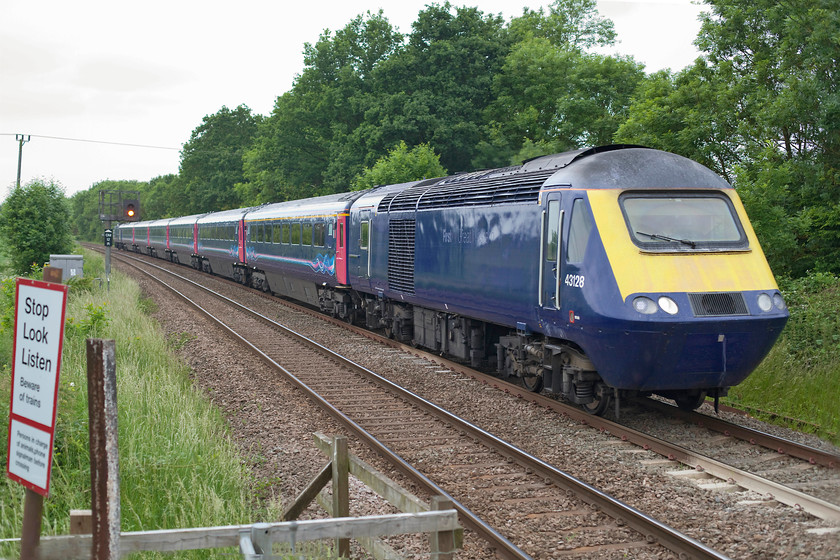 43128 & 43125, 14.41 Chaddesden-Ely Papwirth Sidings ECS for storage (5L46), Egleton SK869070 
 Now unbranded and with an uncertain future, an HST set makes its way through the Rutland countryside on its way for storage. The set is led by 43128 and is seen passing Egleton just south of Oakham. It was running as the 5L46 14.41 Chaddesden (Derby) to Papworth sidings (Ely). On arrival at Ely, the power cars were detached from the coaching stock and later returned to Brush at Loughborough in a back to back formation. Here they will undergo refurbishment in preparation for future use. 43128 was part of a later batch of HST delivered to the Western Region during 1981 and was, initially, part of set 253029. 
 Keywords: 43128 43125 14.41 Chaddesden-Ely Papwirth Sidings ECS for storage (5L46) Egleton SK869070