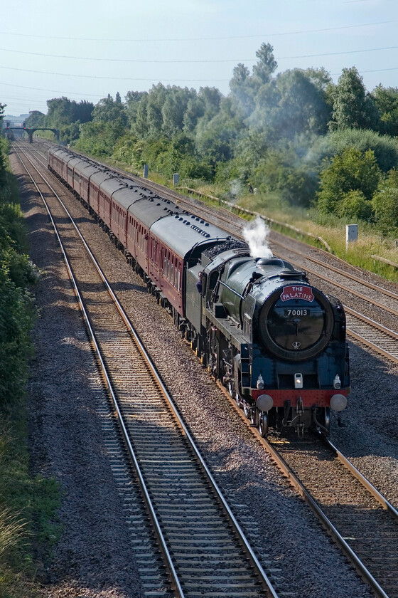 70013, outward leg of The Yorkshireman, 06.30 London Victoria-York (1Z82), Lower Farm Road, Bromham TL028518 
 With it being a warm summer's morning it was unlikely that there would be many signs of an exhaust from 70013 'Oliver Cromwell' and, indeed, this is the case as it passes Bromahm between Bedford and Sharnbrook! In fact, it seems to have steam to spare that is probably a good thing as it prepares for the climb of Sharbrook Bank. Despite wearing a Palatine headboard the title of the charter was titled The Yorkshireman that left Victoria at 06.30 and was heading for York as part of the Mallard 75 celebrations. 
 Keywords: 70013 The Yorkshireman 06.30 London Victoria-York 1Z82 Lower Farm Road, Bromham TL028518 Oliver Cromwell