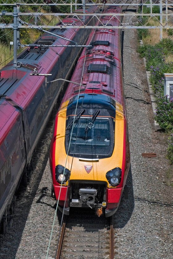 Class 221, VT 08.55 Holyhead-London Euston & Class 390, site of Roade station 
 A passing of Virgin West Coast services at the site of Roade's former station. To the left a Class 390 heads north whilst an unidentified Class 221 Voyager passes south working the 08.55 Holyhead to London Euston service. 
 Keywords: Class 220 08.55 Holyhead-London Euston Class 390 site of Roade station VWC Virgin West Coast