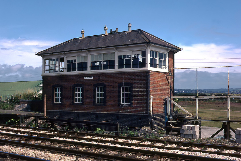 Dawlish Warren Signal Box (GW, date not known) 
 I have no date for the construction of Dawlish Warren signal box but I suspect that it would be early twentieth century. It is a classic GW design and looks smart in the afternoon sunshine. Unfortunately, the same cannot be said of the wooden platform that has been partially removed and is in the process of shortened. 
 Keywords: Dawlish Warren Signal Box