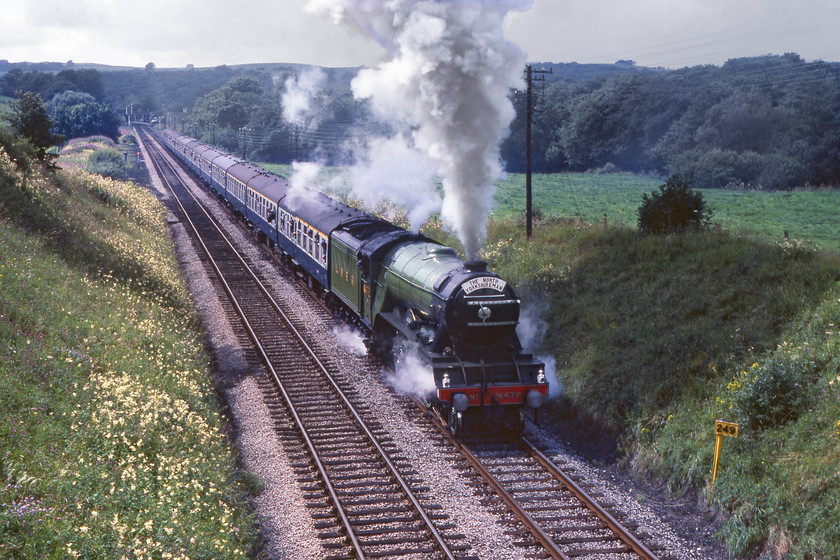 4472, outward leg of The North Yorkshireman, Carnforth-Skipton, Wennington SO625700 
 4472 'Flying Scotsman' is getting into its rhythm as it leaves Wennington on the 1:141 rising gradient towards Bentham. It will have had its work cut out as it appears to have thirteen coaches attached as it leads the outward leg of The North Yorkshireman railtour that originated at Carnforth. Notice the milepost to the right indicating two hundred and forty-nine miles from London St. Pancras via the traditional Midland route. The image is a little side-lit but at least the sun has come out. 
 Keywords: 4472 The North Yorkshireman Carnforth-Skipton Wennington SO625700