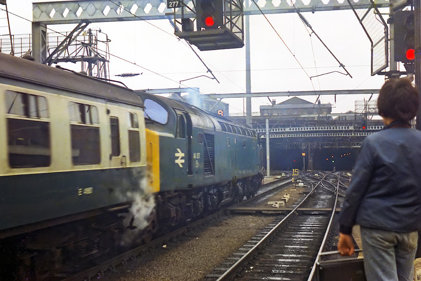 40057, down football special, London Kings Cross station 
 My friend Simon Petrameredies holds my ITT 1001 radio cassette recorder to capture the sounds of 40057's classic English Electric 16SVT Mk. II engine as it leaves King's Cross with an unidentified down footex. Its steam heating boiler is working well as it eases out of the station towards Gasworks Tunnel. 40057 succumbed to the scrapman very late in July 1984 because of a common fault that afflicted many members of the class, namely bogie fractures. 
 Keywords: 40057 down football special London Kings Cross station