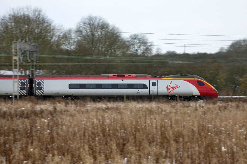 390020, VT 10.07 London Euston-Liverpool Lime Street, Roade 
 The final of my trio of pan photographs taken in the snow at Roade sees 390020 speeding northwards working the 10.07 London Euston to Liverpool Lime Street service. It really is time for me to head carefully home now on my crutches and have a rest and my wife will never know that I have been out; unless she reads this webpage that is! 
 Keywords: 390020 10.07 London Euston-Liverpool Lime Street Roade Virgin West Coast Pendolino