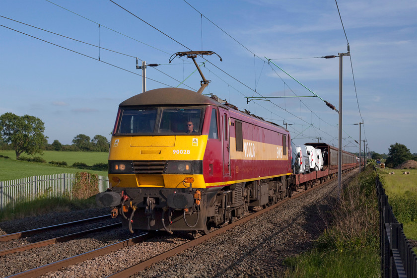 90028, 13.58 Dagenham-Mossend (6X77), Milton Malsor 
 90028 passes Milton Malsor near to Northampton heading the 6X77 13.58 Dagenham to Mossend Ford train. Whilst most of the new vehicles are conveyed in covered wagons, the Transits are left exposed to the elements as can be seen directly behind 90028! 
 Keywords: 90028 13.58 Dagenham-Mossend Ford 6X77 Milton Malsor