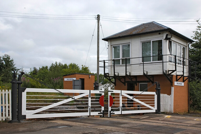 Holywood signal box (GSW, c.1920) 
 This is as far north as Andy and I travelled on our epic two-day trip. This delightful structure is Holywood signal box located on the former G&SWR mainline from Carlisle to Glasgow a few miles north of Dumfries.It is a nice example of one of the few remaining G&SWR Type 7 structures built c.1920 replacing an earlier box of 1878 that was located on the same spot. Despite its replacement windows, the UPVC cladding and the adjacent personal needs building to the left it retains most of its charm in this very rural spot. The gates, which do not appear to be locked into their shoes, remain the last ones in Scotland to operated by a wheel in the box. 
 Keywords: Holywood signal box GSW 1920